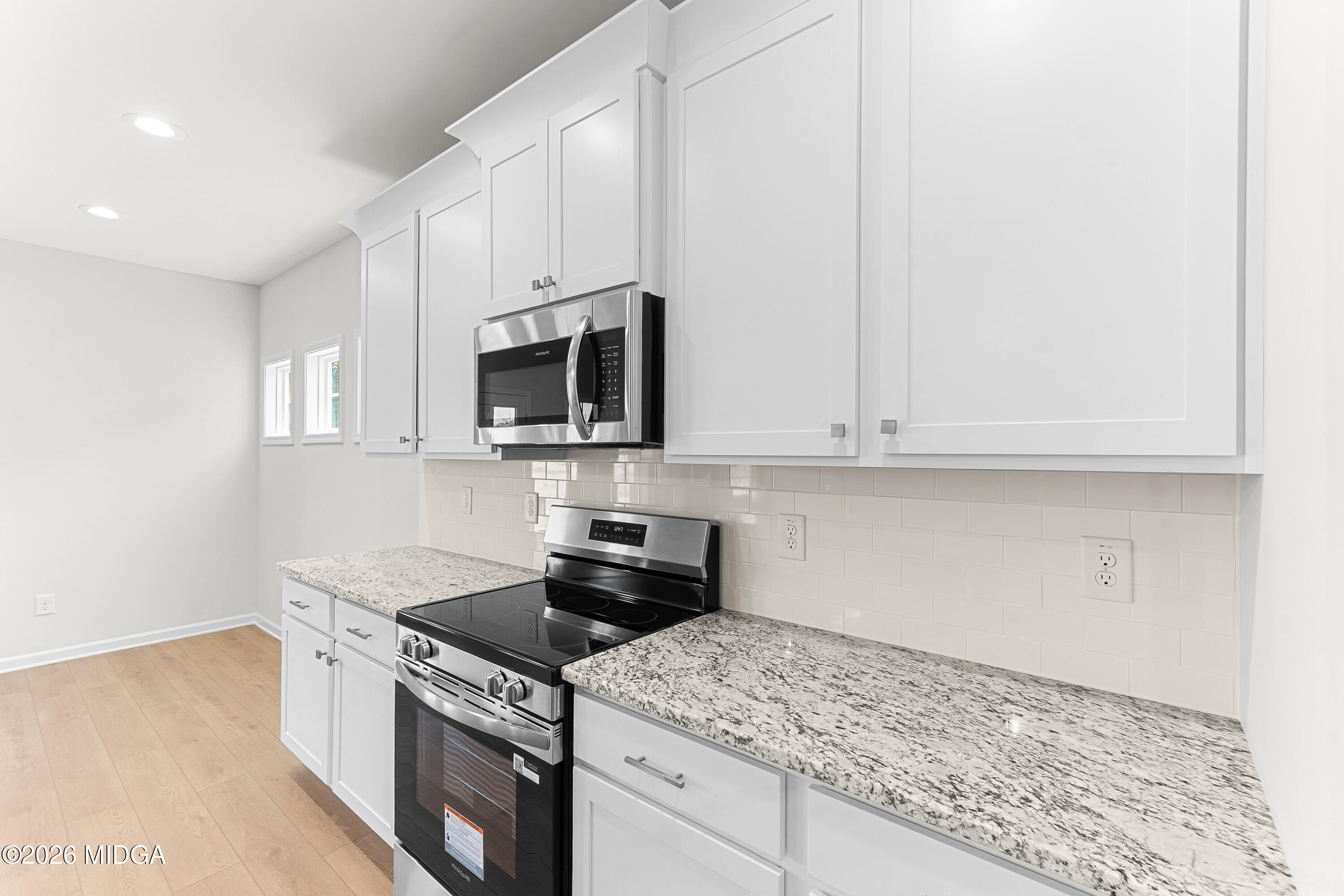 5393 Felles Way, Unit 359 Forsyth, GA 31029 - Photo 19 of 54 a kitchen with stainless steel appliances granite countertop white cabinets and a stove