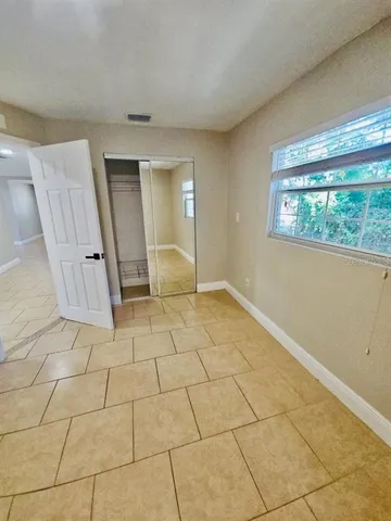 a view of a livingroom with wooden floor and a window