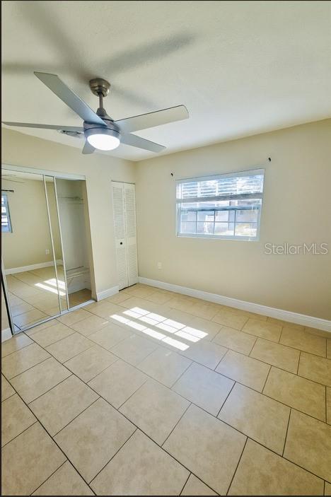 1310 West Burger Street Tampa, FL 33604 - Photo 12 of 14 a view of empty room with wooden floor and fan