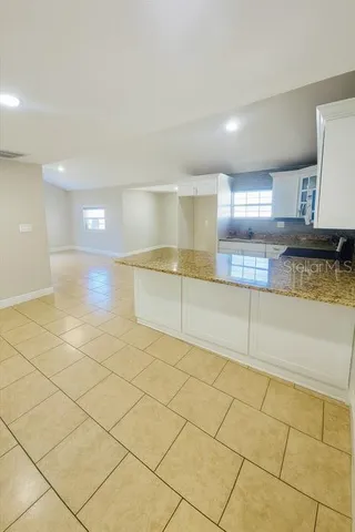 a view of a kitchen with a sink and cabinets