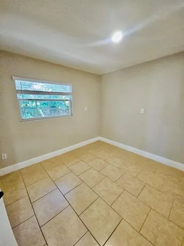 a view of a room with an empty space and a window