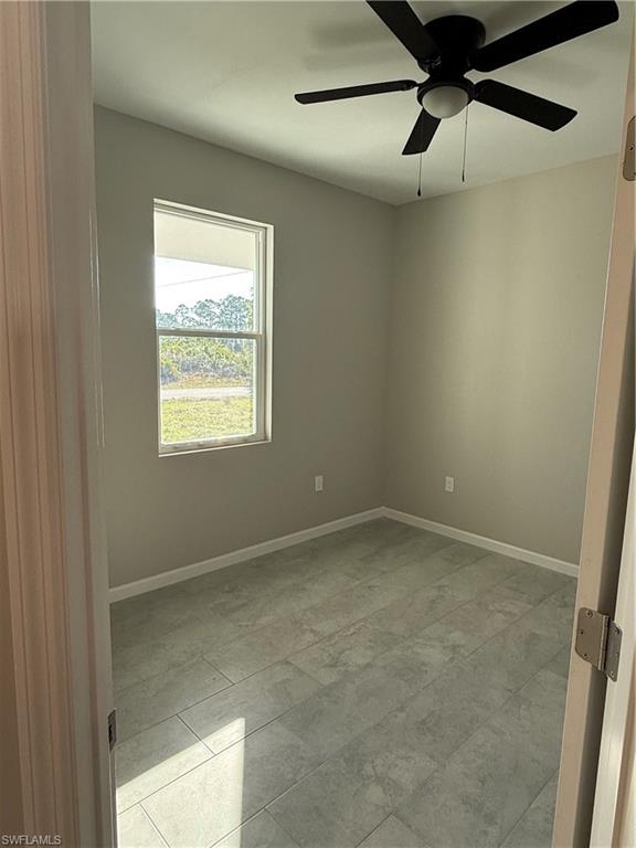 832 Holmes Avenue Lehigh Acres, FL 33974 - Photo 25 of 25 a view of an empty room with a window