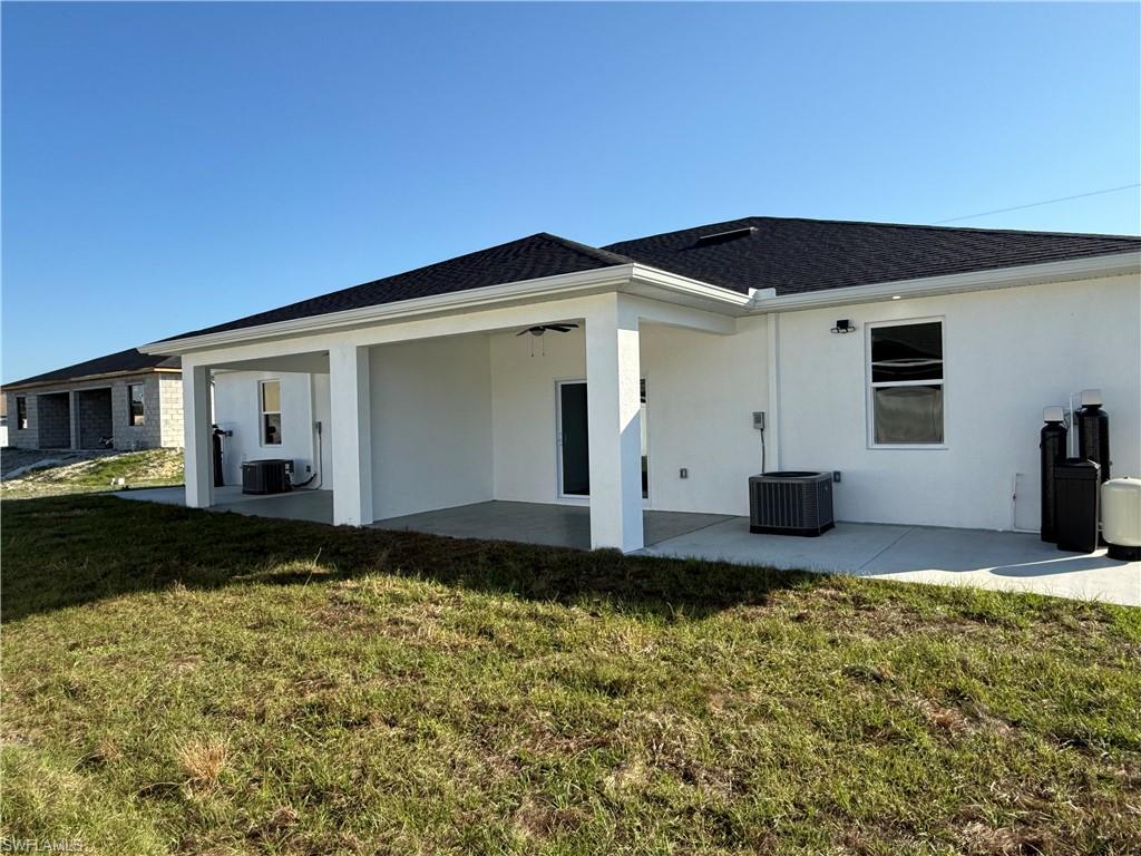 832 Holmes Avenue Lehigh Acres, FL 33974 - Photo 6 of 25 a front view of a house with garden