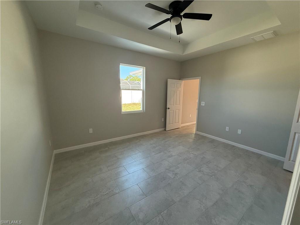 832 Holmes Avenue Lehigh Acres, FL 33974 - Photo 10 of 25 an empty room with a window and a fan