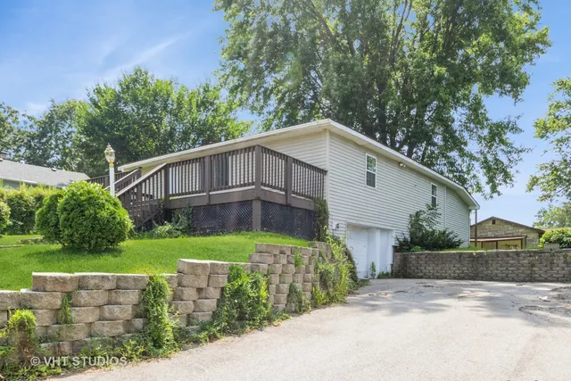 a view of a house with a yard and plants