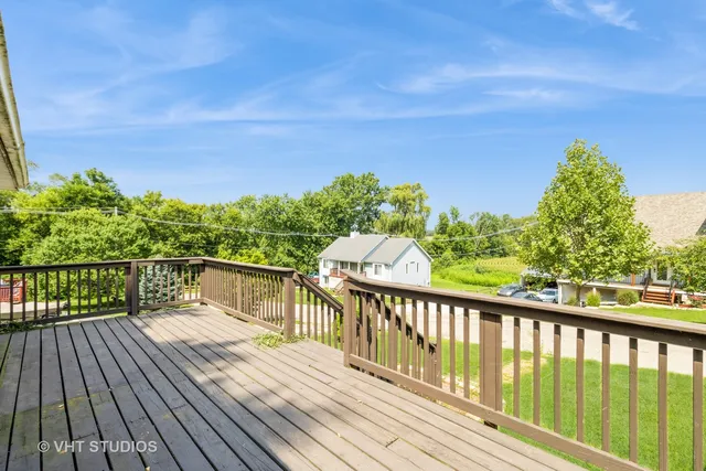 a view of balcony with wooden floor and fence