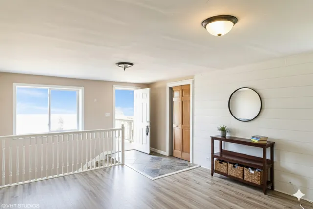a view of a room with wooden floor and windows