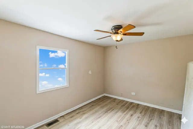 a view of a room with a window and a fan