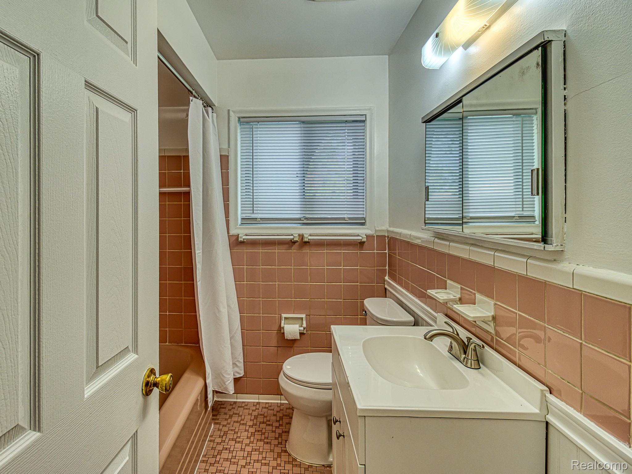 8501 Allen Road Allen Park, MI 48101 - Photo 9 of 27 Bathroom with vanity, shower / tub combo, tile walls, and a wainscoted wall