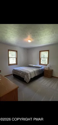 a view of backyard with a deck and wooden floor