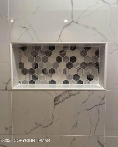 a bedroom with a bed flat screen tv and a window