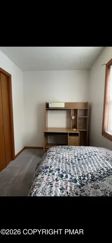 a view of a house with car parked