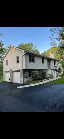 a view of kitchen with stainless steel appliances wooden floor