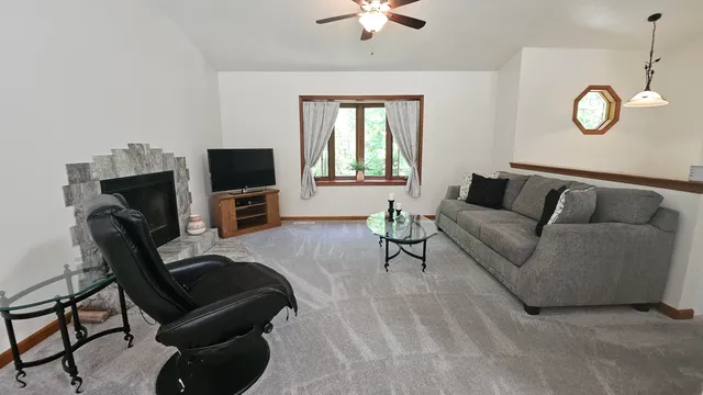 a living room with furniture flat screen tv and a fireplace