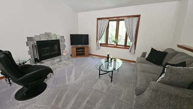 a dining room with furniture a chandelier and window