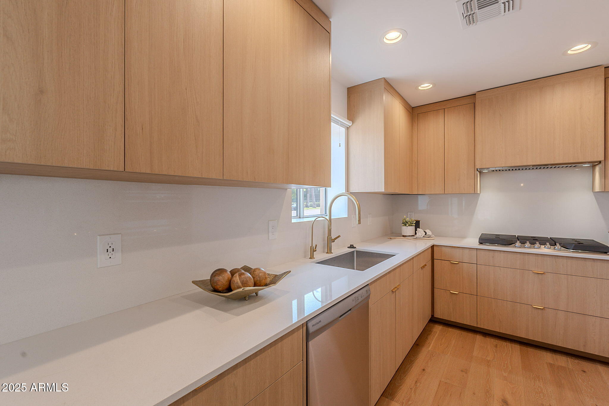 502 East Osborn Road Phoenix, AZ 85012 - Photo 16 of 24 a kitchen with a sink a stove and cabinets
