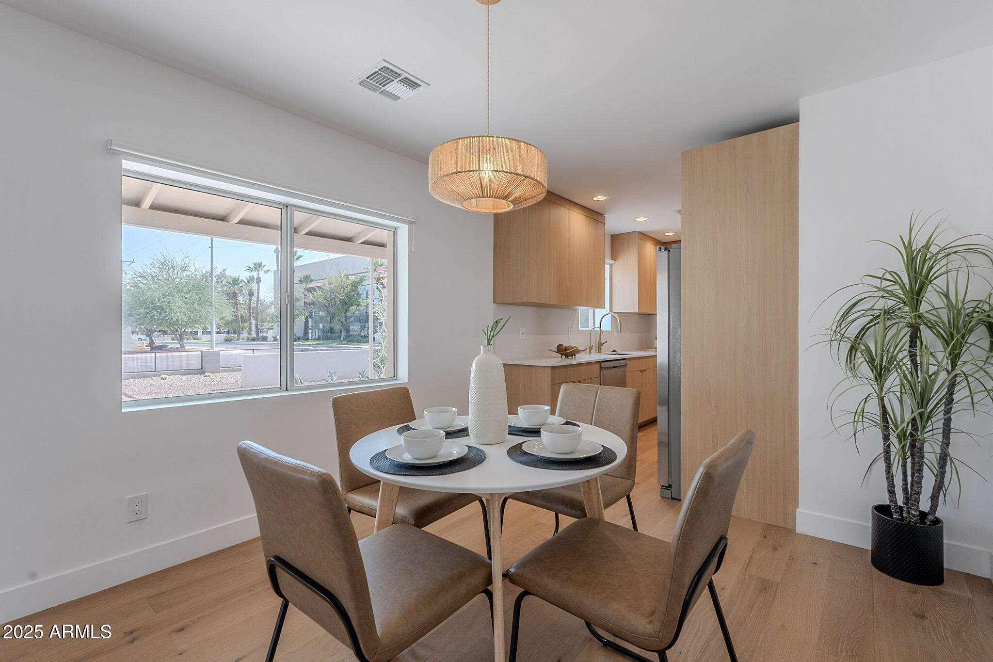 502 East Osborn Road Phoenix, AZ 85012 - Photo 18 of 24 a dining room with furniture potted plants and wooden floor