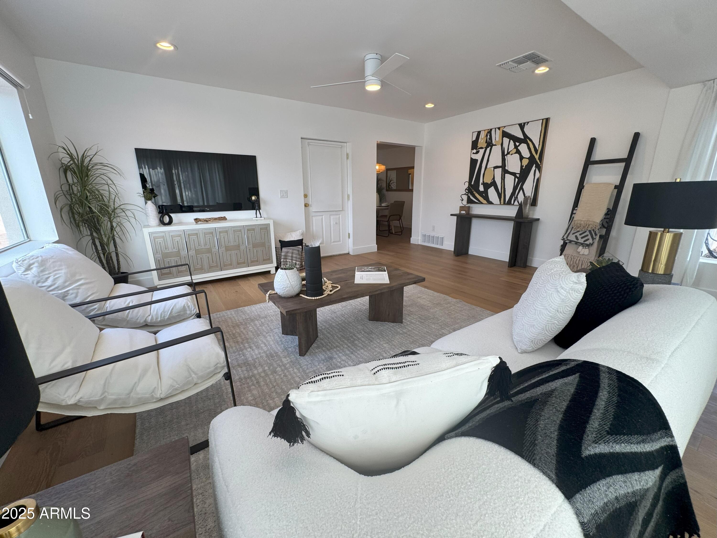 502 East Osborn Road Phoenix, AZ 85012 - Photo 3 of 24 a living room with furniture and a flat screen tv