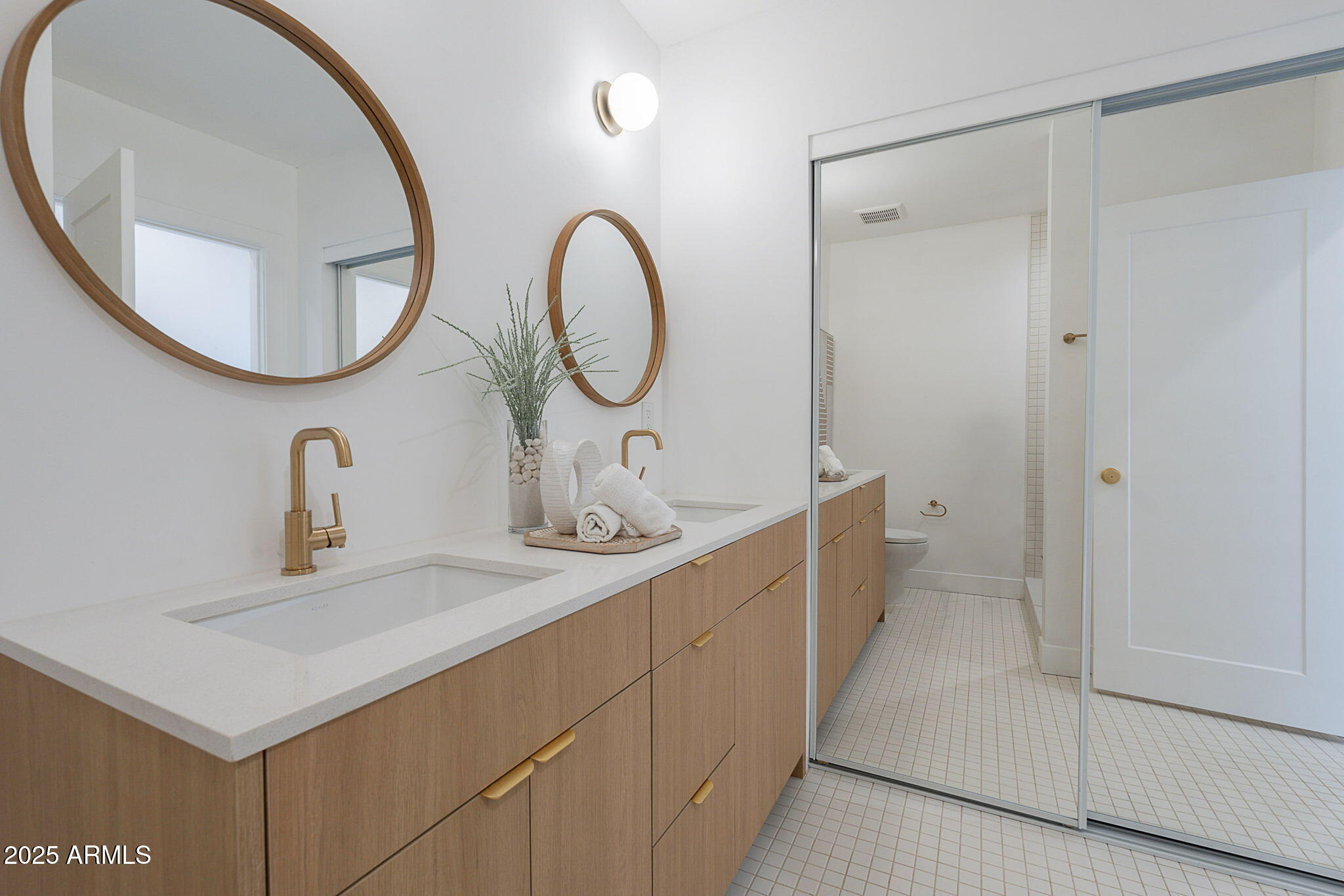 502 East Osborn Road Phoenix, AZ 85012 - Photo 4 of 24 a bathroom with a double vanity sink and a mirror