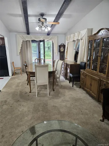 a view of a livingroom with furniture window and wooden floor