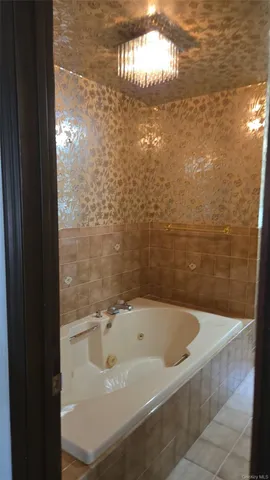 a bath tub sitting in a bathroom next to a white wall