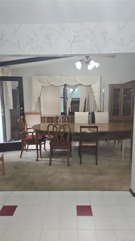 a living room with lots of furniture and view of kitchen