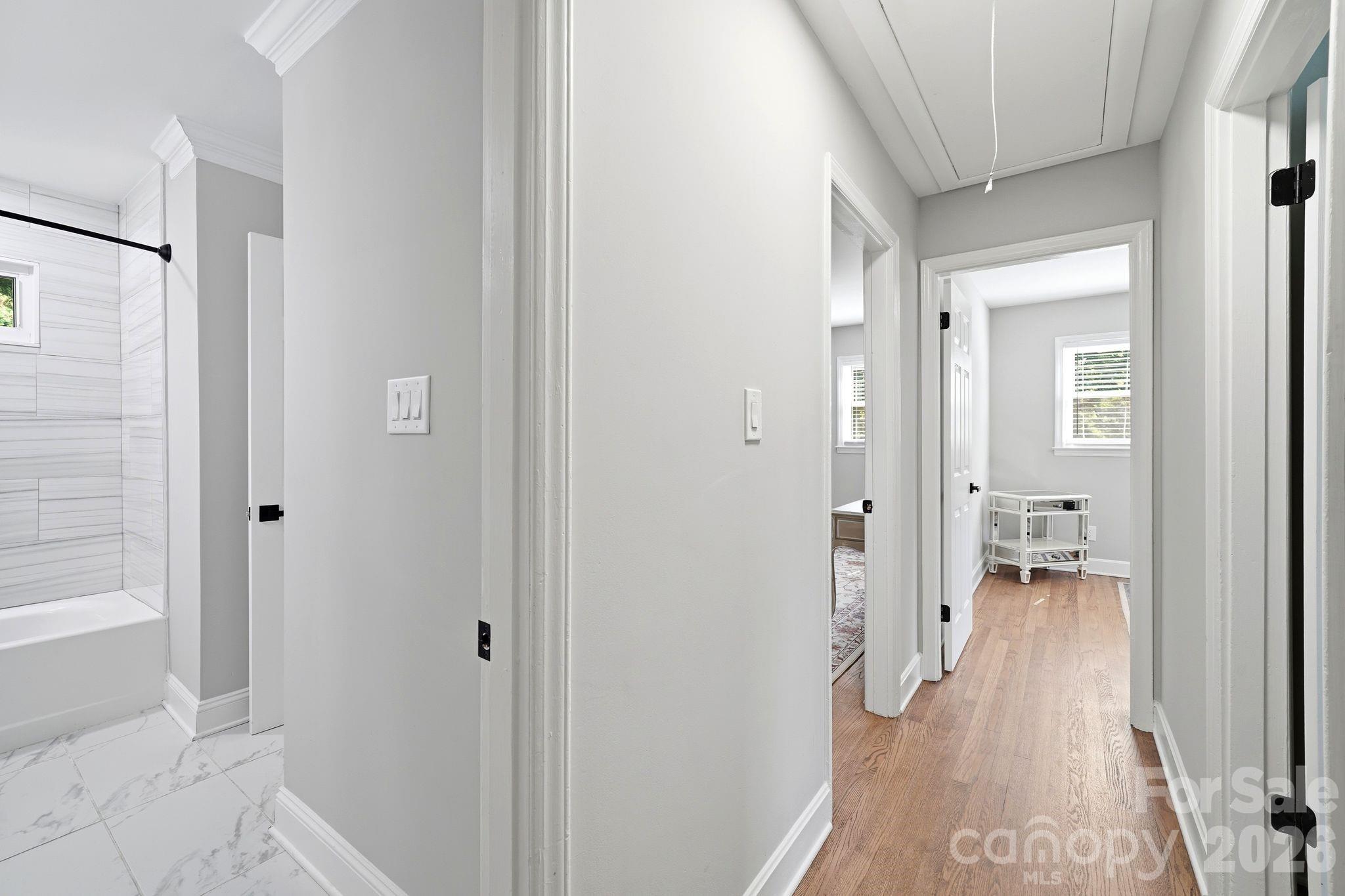 7552 Idlewild Road Charlotte, NC 28212 - Photo 15 of 40 a hallway with wooden floor and closet