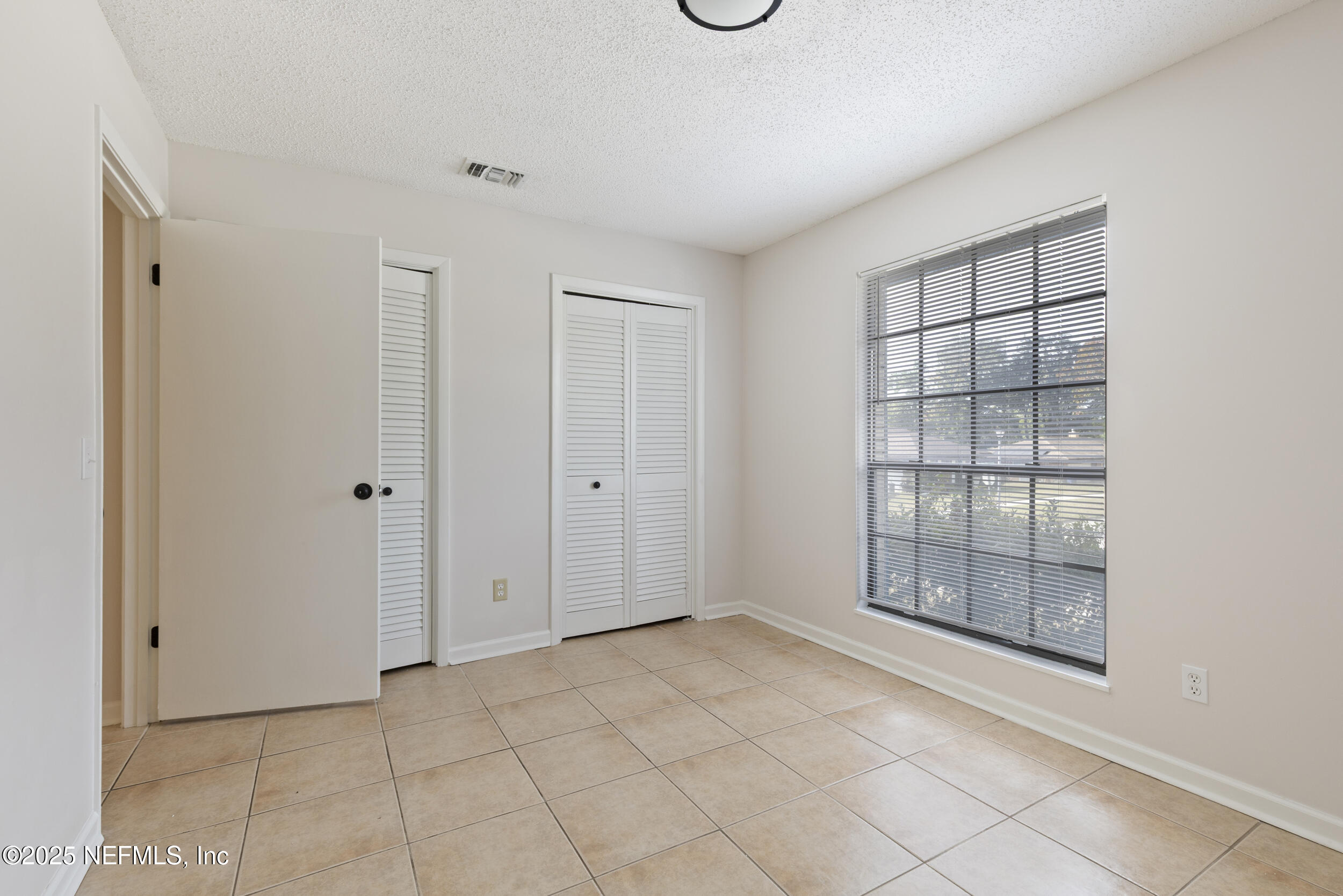 4135 Dawnridge Road East Jacksonville, FL 32277 - Photo 11 of 26 a view of an empty room with window