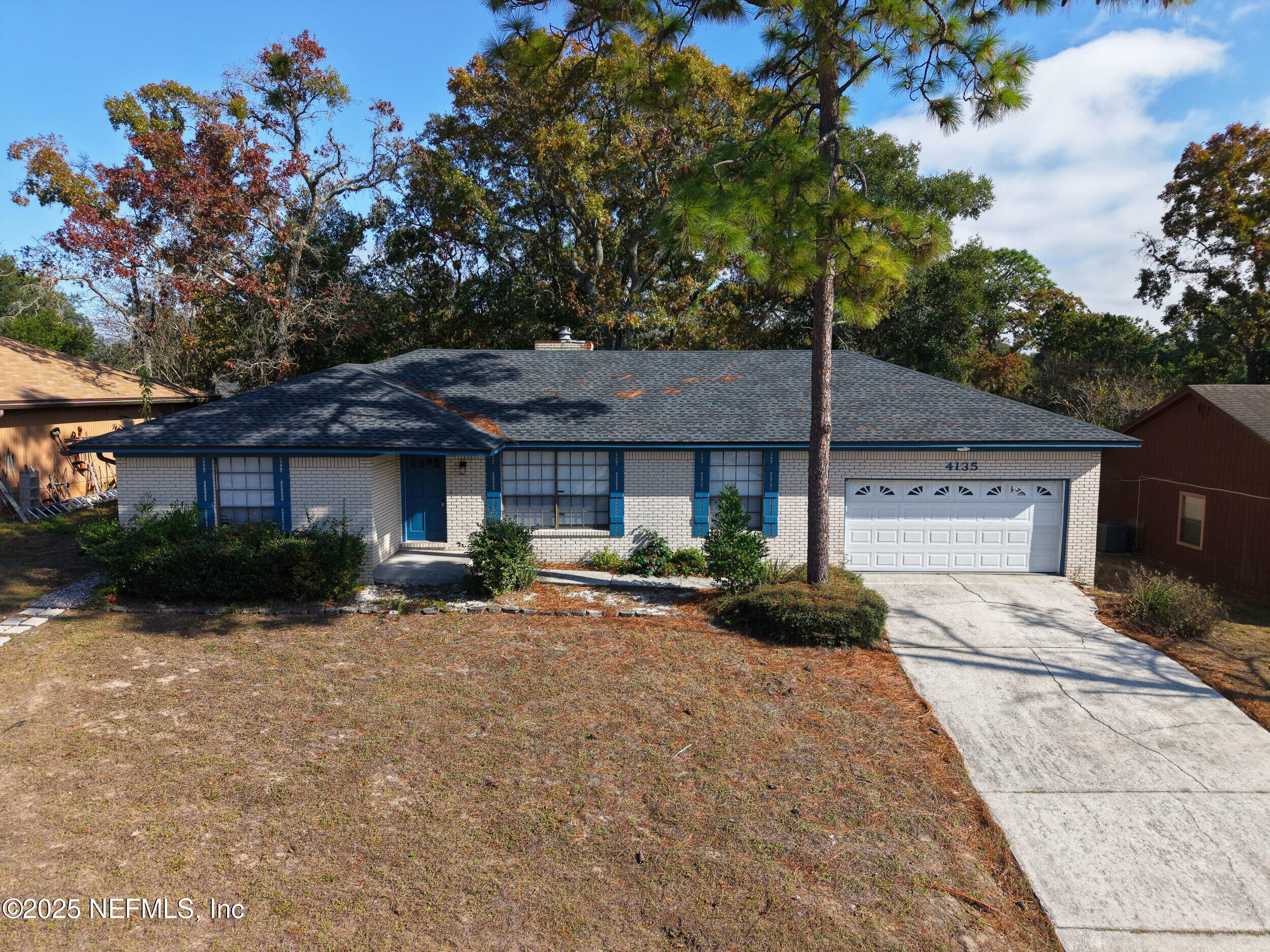 4135 Dawnridge Road East Jacksonville, FL 32277 - Photo 25 of 26 a front view of a house with a yard and garage