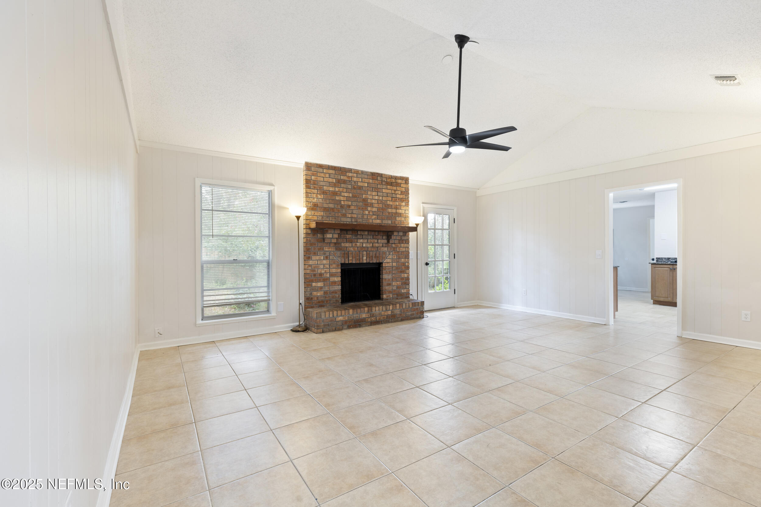4135 Dawnridge Road East Jacksonville, FL 32277 - Photo 5 of 26 a view of an empty room with a fireplace and a window