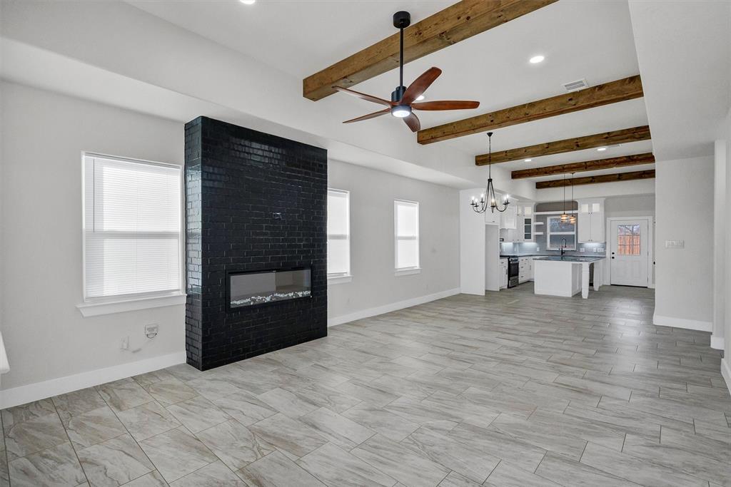 517 Highview Court Godley, TX 76044 - Photo 11 of 39 a view of an empty room with a window and wooden floor