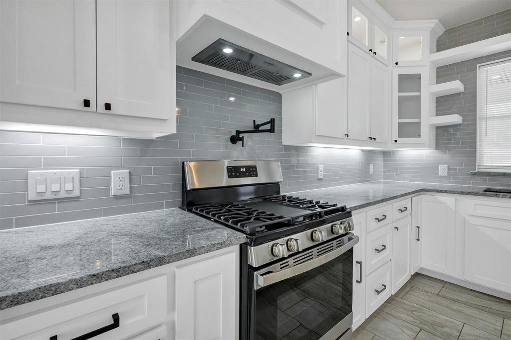 517 Highview Court Godley, TX 76044 - Photo 13 of 39 a kitchen with granite countertop white cabinets and appliances