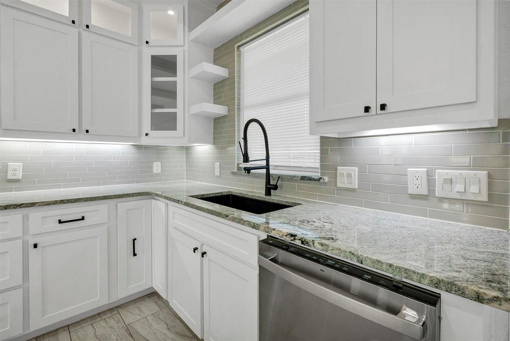 517 Highview Court Godley, TX 76044 - Photo 14 of 39 a kitchen with granite countertop white cabinets and a stove