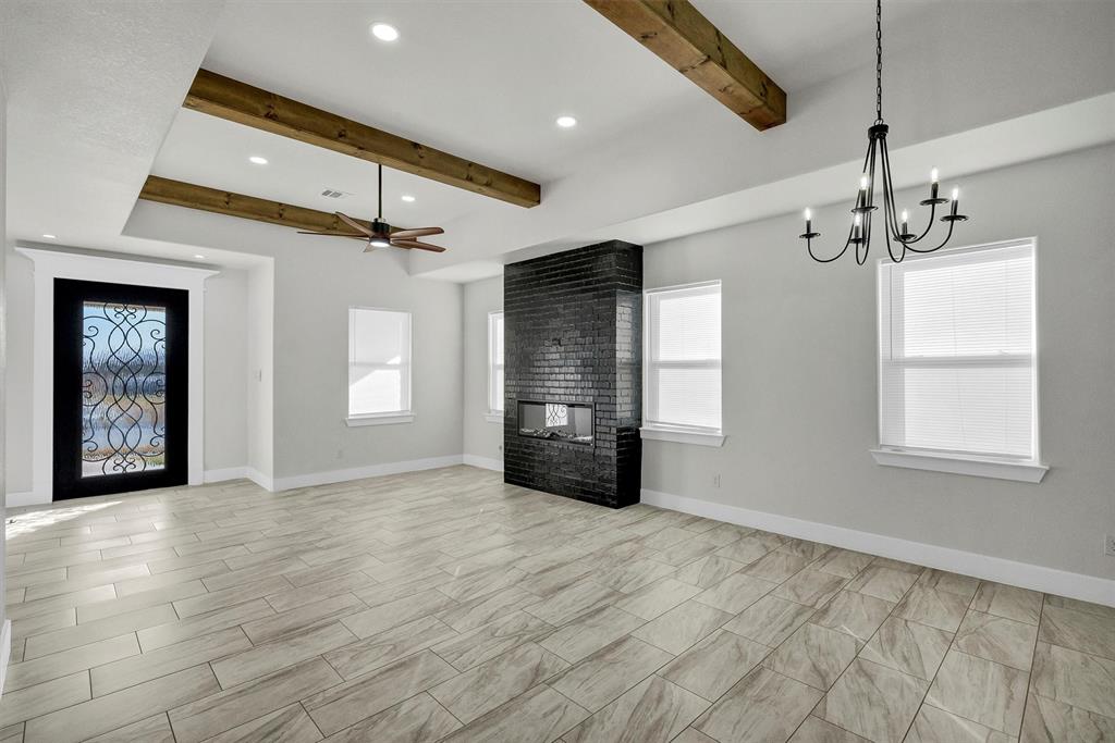 517 Highview Court Godley, TX 76044 - Photo 30 of 39 a view of an empty room with a window and fireplace
