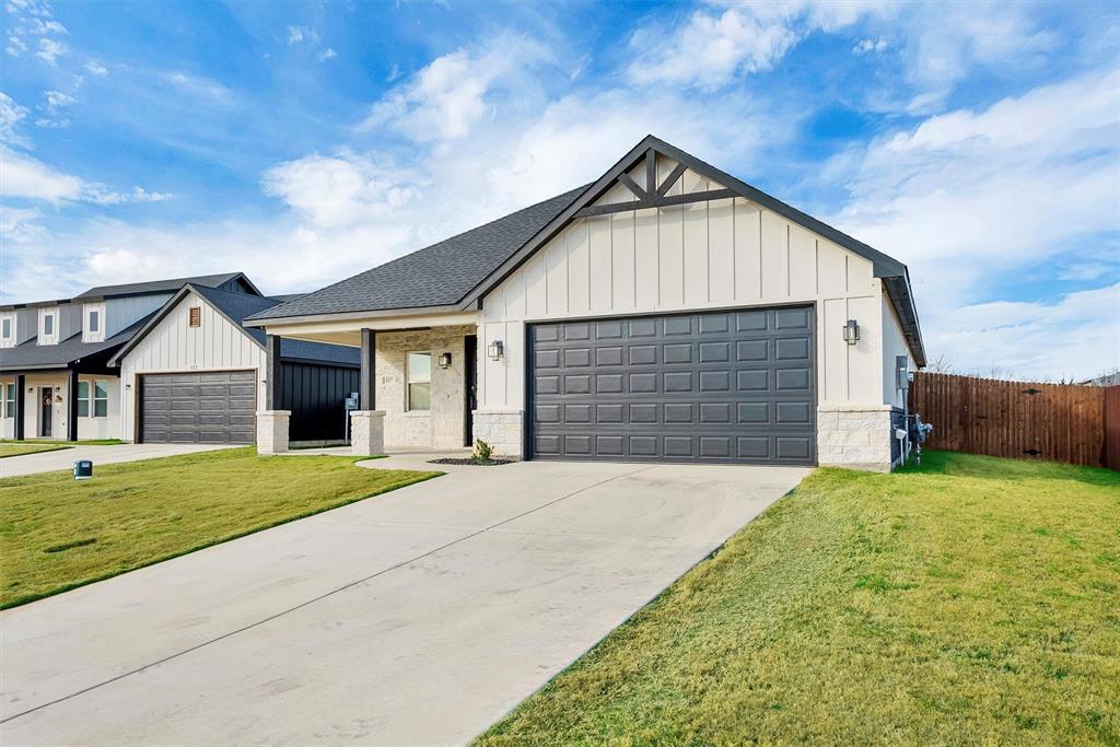 517 Highview Court Godley, TX 76044 - Photo 3 of 39 a front view of a house with a yard and garage