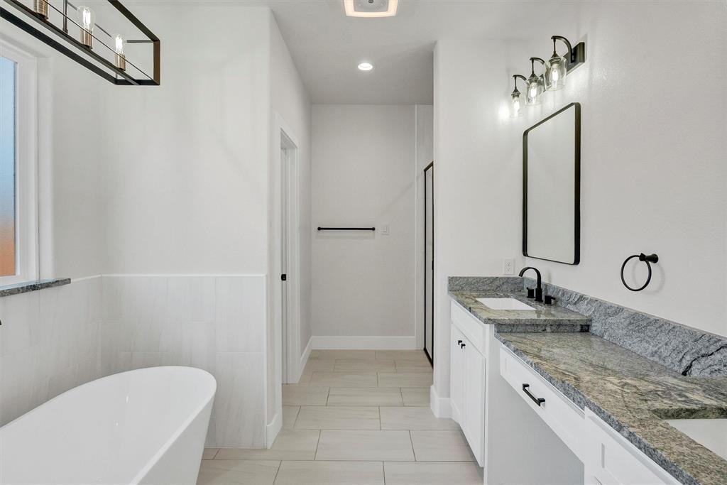 517 Highview Court Godley, TX 76044 - Photo 31 of 39 a spacious bathroom with a granite countertop sink a toilet and a mirror