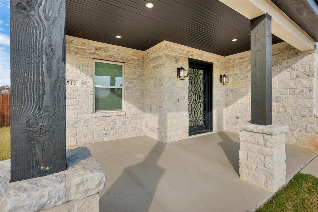 517 Highview Court Godley, TX 76044 - Photo 5 of 39 a bathroom with a granite countertop sink a mirror and shower