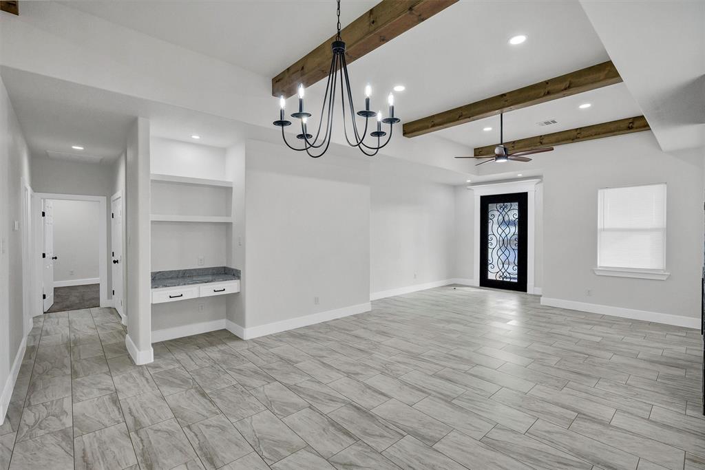 517 Highview Court Godley, TX 76044 - Photo 8 of 39 an empty room with wooden floor and windows