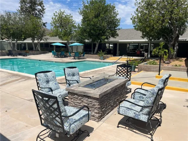 a view of a patio with couches chairs and a yard