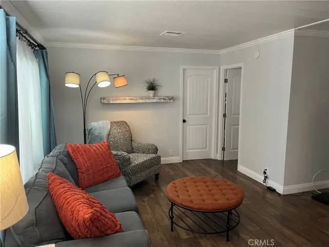 a living room with furniture and a mirror