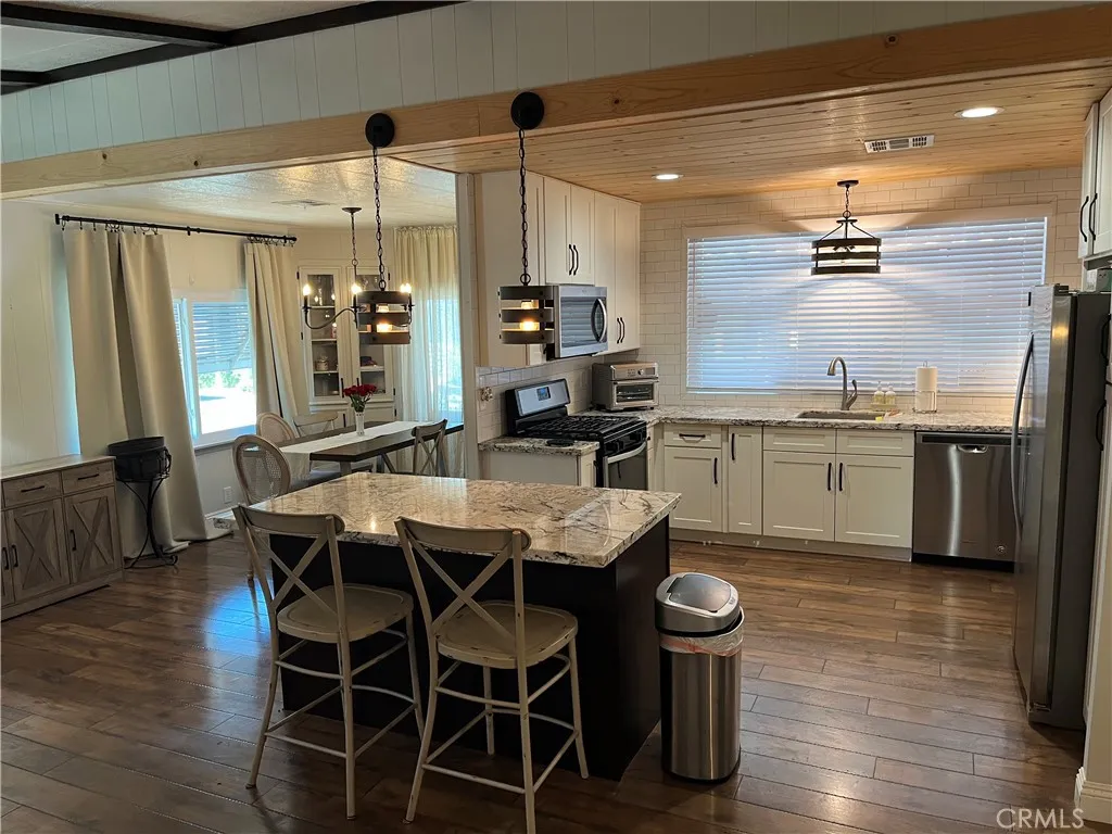 4000 Pierce Street, Unit 284 Riverside, CA 92503 - Photo 10 of 32 a kitchen with a table and chairs in it