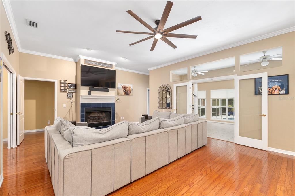 9350 Southwest 46 Place Gainesville, FL 32608 - Photo 13 of 63 a living room with furniture a flat screen tv and a fireplace