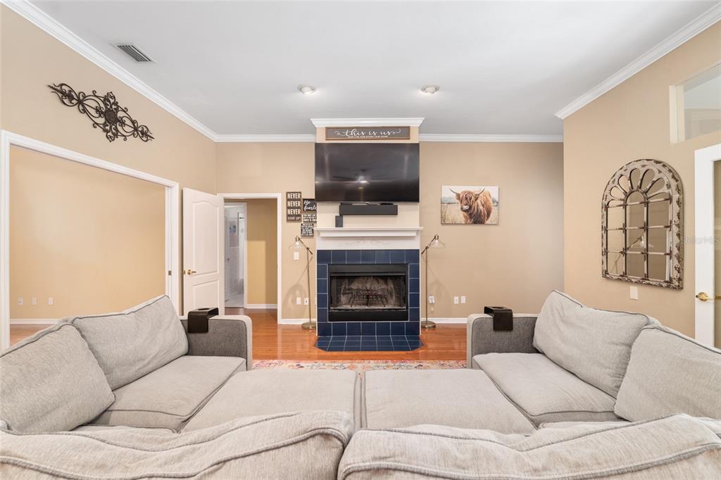 9350 Southwest 46 Place Gainesville, FL 32608 - Photo 14 of 63 a living room with furniture a flat screen tv and a fireplace