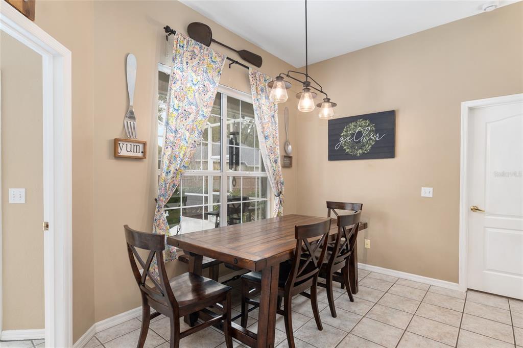 9350 Southwest 46 Place Gainesville, FL 32608 - Photo 19 of 63 a view of a dining room with furniture and chandelier
