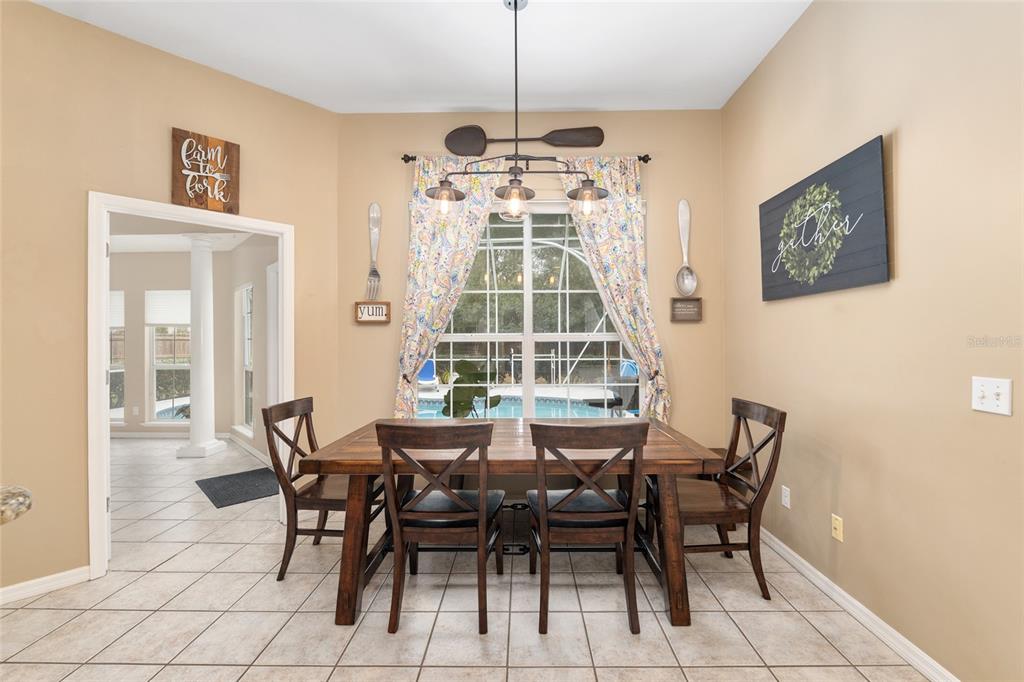 9350 Southwest 46 Place Gainesville, FL 32608 - Photo 20 of 63 a view of a dining room with furniture and a chandelier
