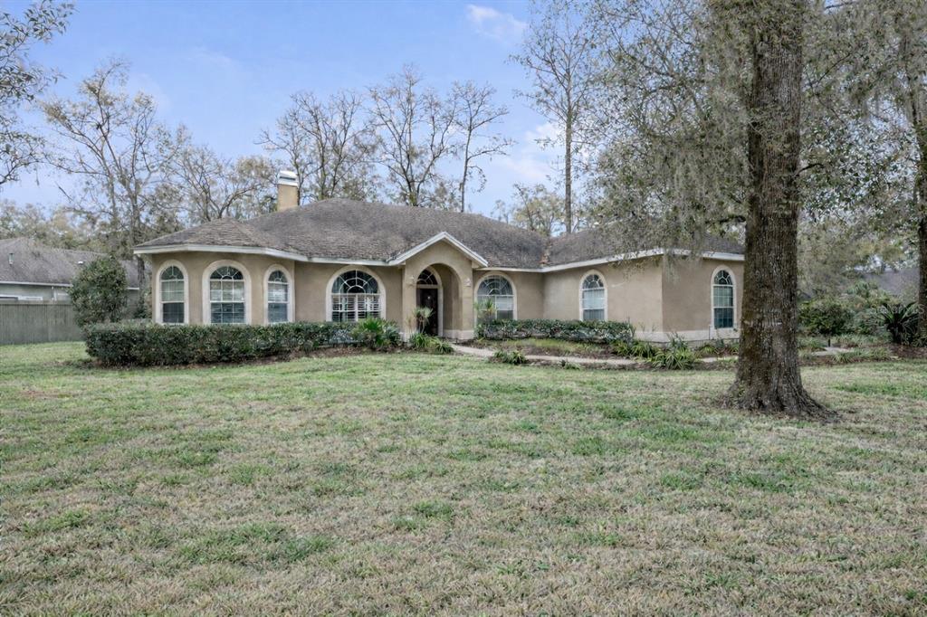 9350 Southwest 46 Place Gainesville, FL 32608 - Photo 3 of 63 a front view of a house with a garden