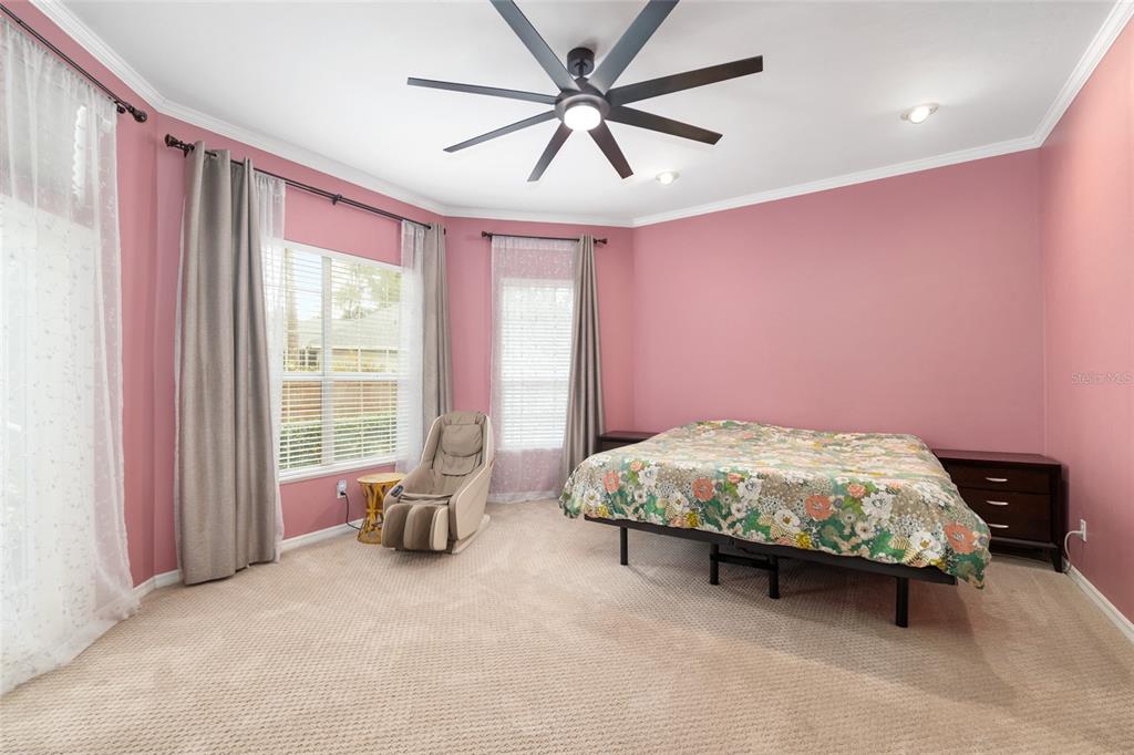 9350 Southwest 46 Place Gainesville, FL 32608 - Photo 31 of 63 a bedroom with a bed and a chandelier