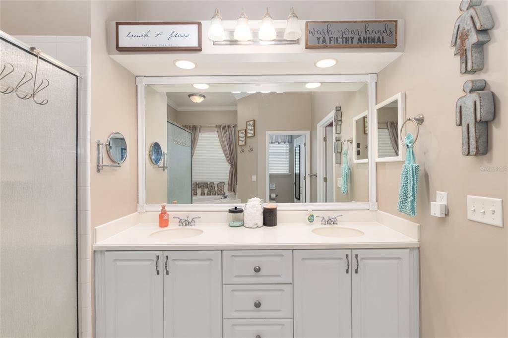 9350 Southwest 46 Place Gainesville, FL 32608 - Photo 37 of 63 a bathroom with double vanity sink and a mirror