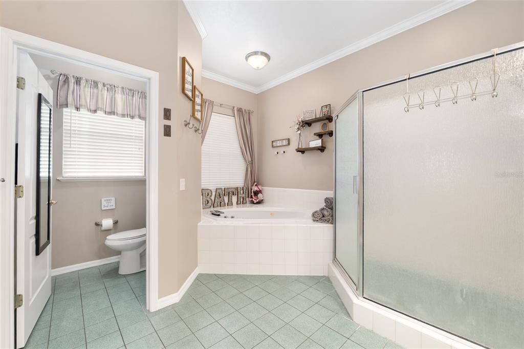 9350 Southwest 46 Place Gainesville, FL 32608 - Photo 38 of 63 a bathroom with a shower a bathtub and a toilet