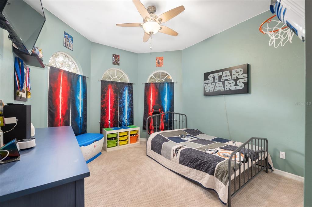 9350 Southwest 46 Place Gainesville, FL 32608 - Photo 41 of 63 a bedroom with a bed and a chandelier